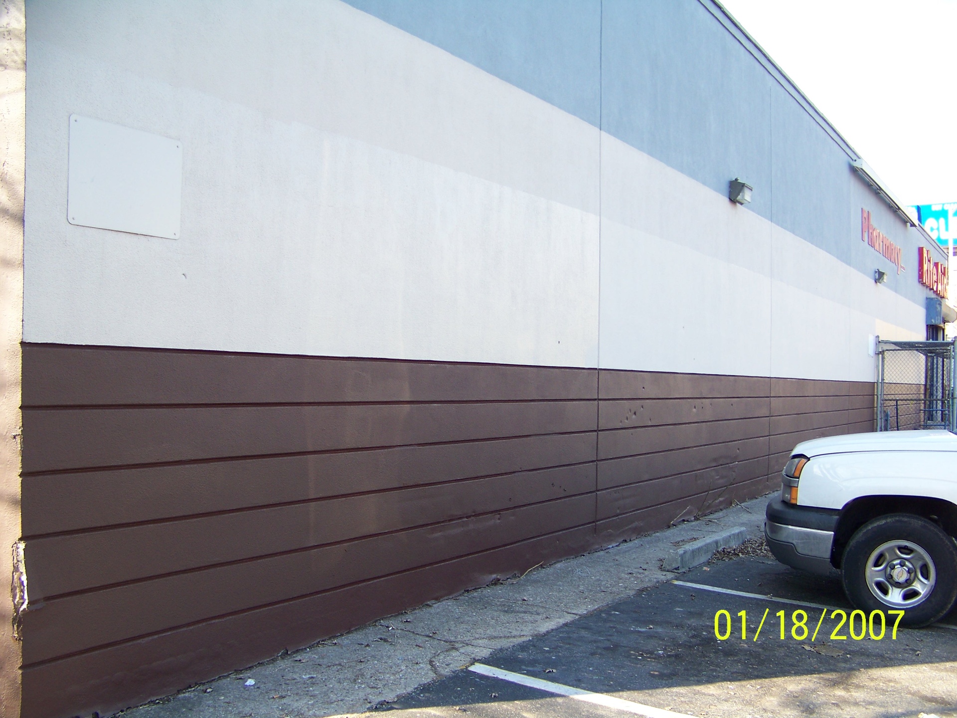 Rite Aid exterior wall freshly painted after graffiti removal