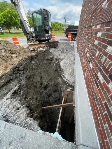 Foundation excavation next to brick building