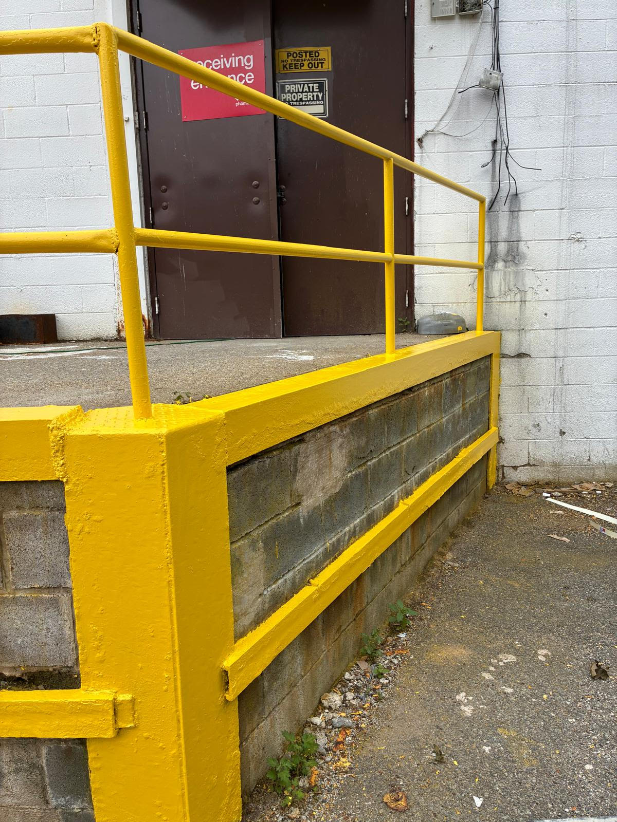 Freshly painted yellow loading dock rail close-up