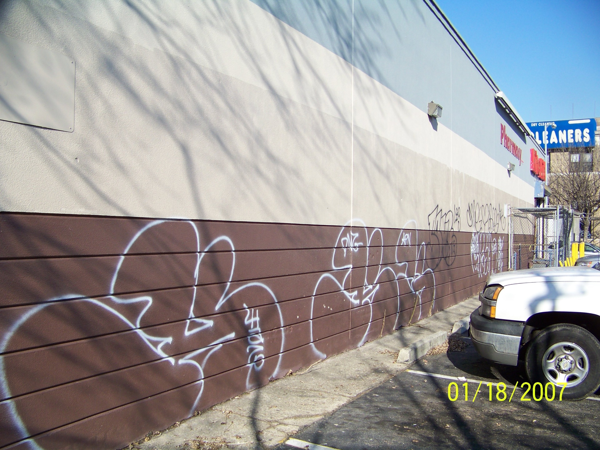 Rite Aid exterior wall covered in graffiti tags before cleaning