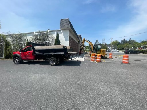Truck and excavator on sitework job