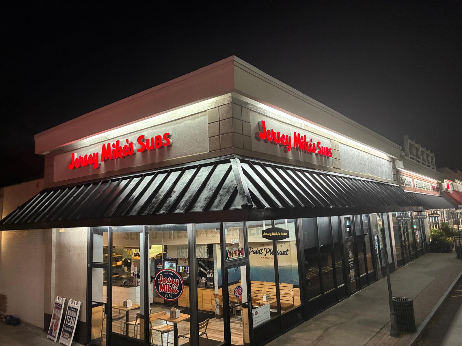 Finished Jersey Mike's storefront awning and facade at night
