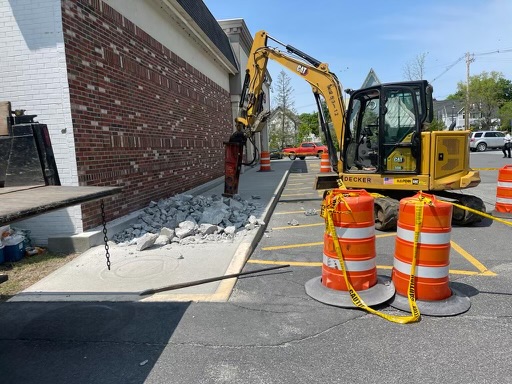 Jackhammer breaking up curb section