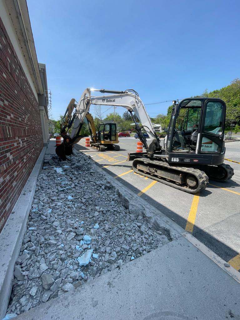 Concrete demolition along storefront
