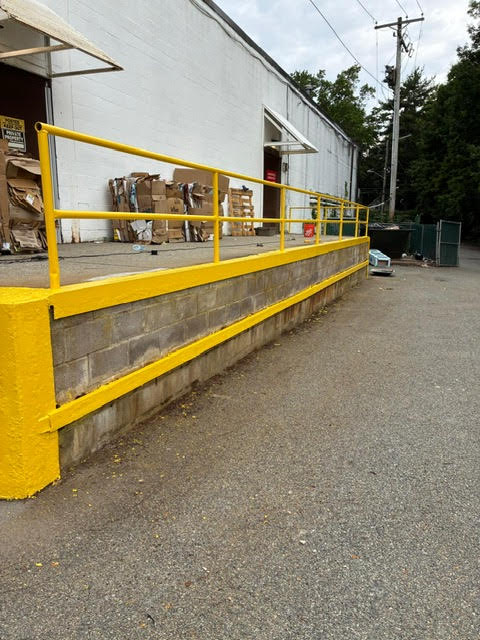 Loading dock with freshly painted yellow safety railing