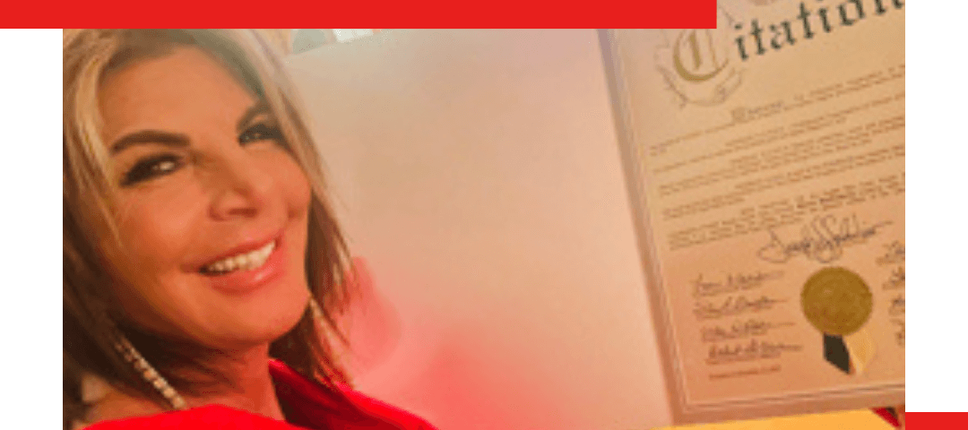 A woman in a red outfit smiles while holding a framed certificate. Text on the image reads “What a Beautiful Surprise: Honored & Grateful.” Blog and Instagram links appear at the bottom.
