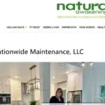 A woman stands and smiles in a modern white kitchen with gold accents, under a headline for Nationwide Maintenance, LLC, on the Natural Awakenings Westchester, Putnam, Dutchess NY website.