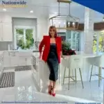 Woman in a red blazer stands in a modern white kitchen with gold fixtures and a dining area. Text promotes Nationwide Maintenance’s kitchen remodel services and offers a free consultation.