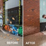 A man in blue overalls cleans a graffiti-covered wall with a pressure washer in the before image; in the after image, the wall is clean and the man sweeps debris from the sidewalk.